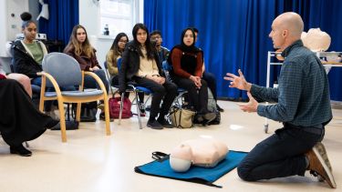 Teacher with respiratory dummy