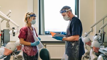 Dentistry Students in room with phantom heads