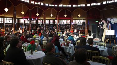 People watching a show inside a spiegeltent at the University of Sheffield's Festival of the Mind