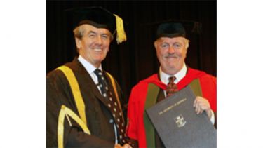 Two male academics in graduation gowns