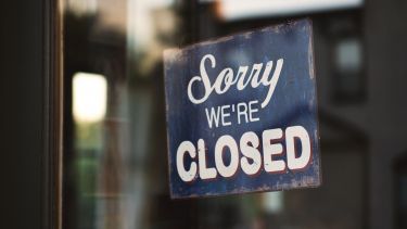A shop sign saying 'sorry we're closed'