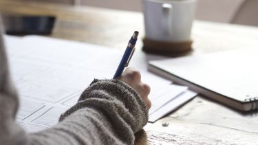 Close up of hand with pen