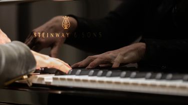 hands playing the piano - close up shot