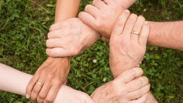 Hands connected to one another