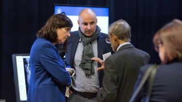 A group having a conversation at the Insigneo showcase 2017.