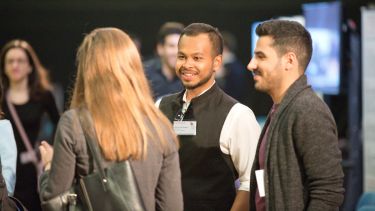 A group having a conversation at the Insigneo showcase 2019.