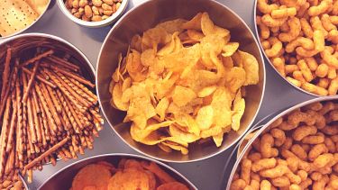Bowls of crisps, nuts and other snacks
