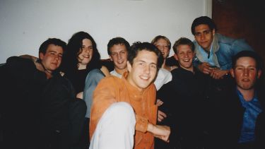 On older photo of Chris sat with a group of housemates