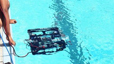 Team member working with the robot at the ROV competition 2018.