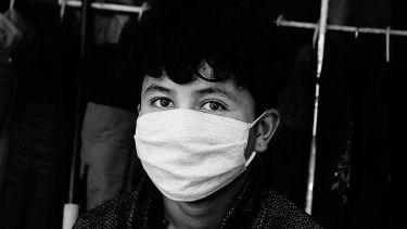 A boy wearing a mask
