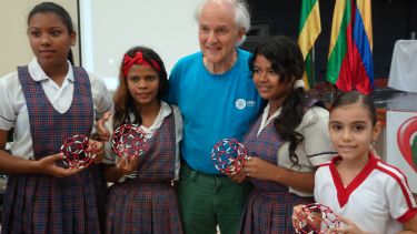 Harry Kroto with a children taking part in a Buckyball workshop.