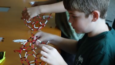 Child taking part in the Buckyball workshop
