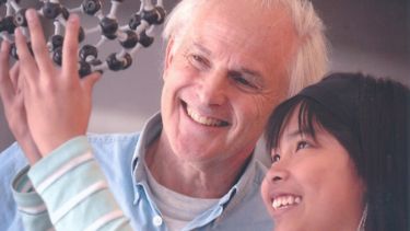 Harry Kroto with a child taking part in a Buckyball workshop.