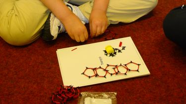 Child taking part in the Buckyball workshop