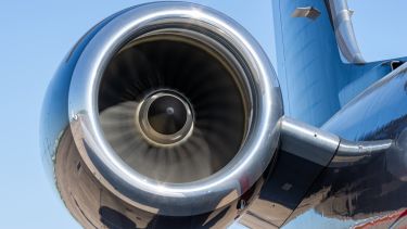 a large shiny jet engine in motion 