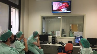 Spinner fellows watching a telecast of live spine surgery