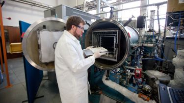 Materials science student doing tests in a pressurised container