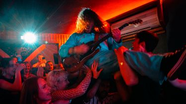guitar player crowd surfing