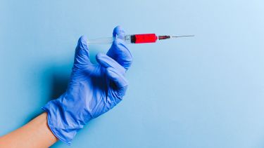 Person holding a syringe