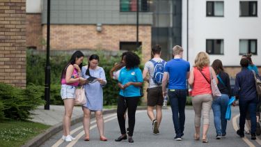 Photo of people walking around the student residences at an open day
