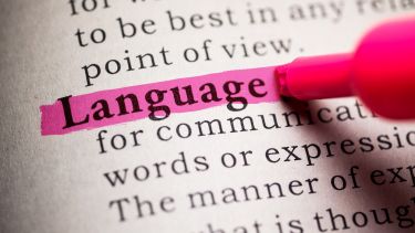 'Language' highlighted in a book by a pink highlighter