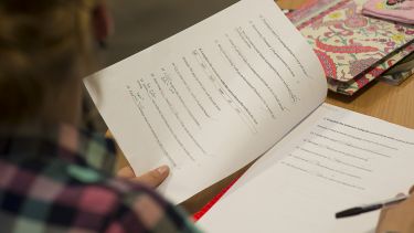 A picture of a student reading a test paper