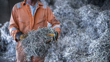 man carrying metal cuts fast forge