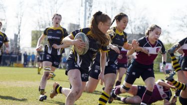 University of Sheffield women's rugby player carrying the ball against Sheffield Hallam as part of Sheffield Varsity