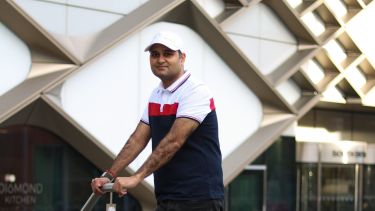 Profile photo of a student standing in front of the Diamond Building 