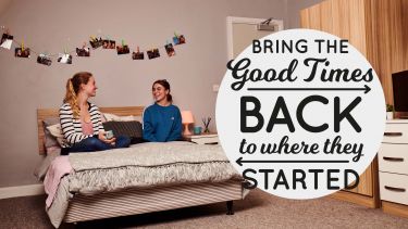 Two female students sat on a bed laughing with logo that reads bring the good times back to where they started