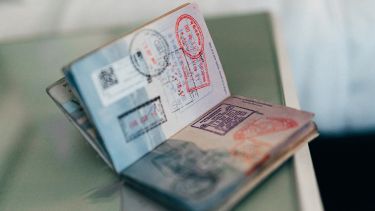 Open passport showing visa stamps