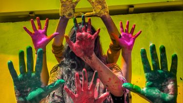 Four people showing painted hands