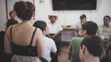 A student asks a question on a field trip