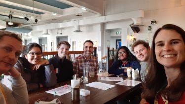 Group of students in a cafe setting for the German Coffee mornings
