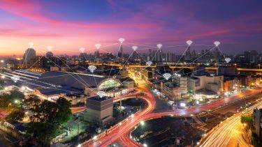 Cityscape at night time showing wireless communications and connectivity