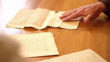 A video screenshot showing the mystery manuscript