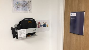 A close-up of the automated external defibrillator in Cathedral Court.