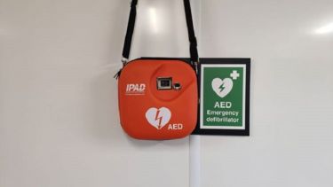 A close-up of the automated external defibrillator in Norton Lower Pavilion.