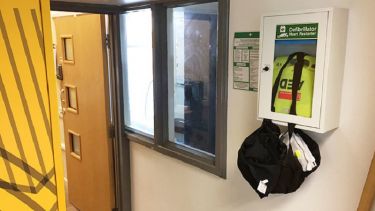 A close-up of the automated external defibrillator in the swimming pool.
