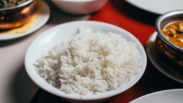 A bowl of rice with other dishes