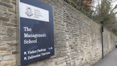 Brick wall on crookesmoor road with which has the management school sign attached