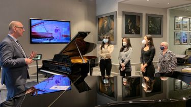 Group on tour at steinway showroom