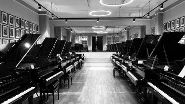 Steinway grand pianos in a line in steinway hall london