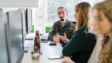 Students discussing careers at the computer