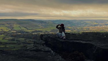 LLM Student QiuYi sitting at Bamford Edge, the Peak District