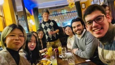 QiuYi enjoying a Christmas Dinner with LLM Course Mates
