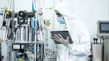 Improve Manufacturing Productivity. Quality Engineer inspecting product in production process at medical industry. - stock photo