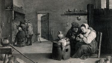 A woman sits by a barrel table in a smoke den lighting a pipe, others stand by the fire.