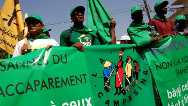 Protestors hold up a banner