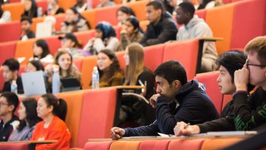 A large number of undergraduate students sat in a lecture theatre.